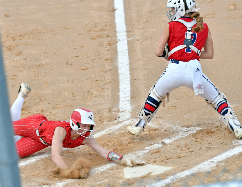 Vivi Fahrnbruch slides safely into home for one of Aurora's two runs in a 12-2 loss to Norris in Thursday's B-7 district tournament. 