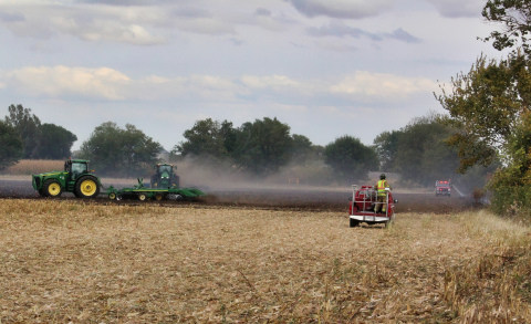 Firefighters and local farmers work to mop up after Saturday's field fire. 