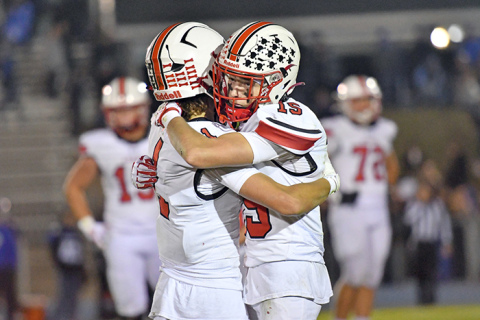Seniors Canon Allen (1) and Ryan Staehr (15) share a moment on the field before taking their helmets off for the last time. 