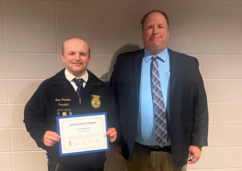 Evan Pankoke (left) of Hampton was one of eight local FFA members to be awarded their American FFA Degrees at the 98th National FFA Convention & Expo held recently in Indianapolis, Ind. He is pictured with his high school FFA advisor, Joel Miller. 
