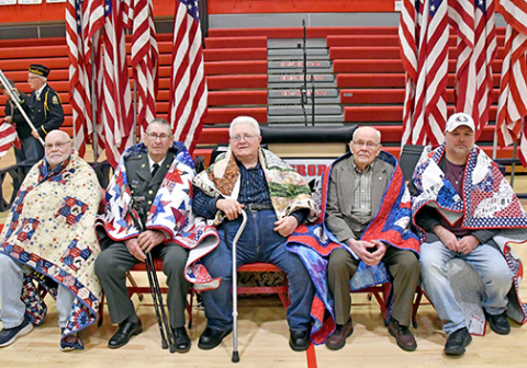 Pictured from left, Warren Anderson, Richard Carnes, Don Harvey, Oscar Lundquist and Travis Stevens received their quilts of valor during a Veteran’s Day program at AHS. 