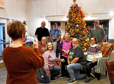 Administrative assistant Jenny Scheil takes a picture of resident Loretta Bykerk (center) with her family. The Christmas tree was declared one of the winners of East Park Villa’s employee decoration contest. It was decorated by Jenny Scheil and the maintenance department.