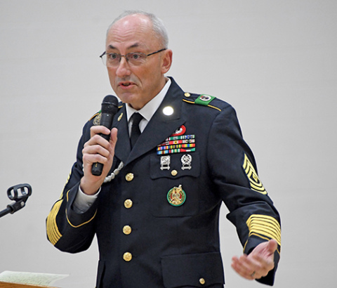 Speaker Chris Hochstetler explained the meaning of the arrangment of medals on his Army uniform to the audience at the Veterans Day program at Hampton last Tuesday. 