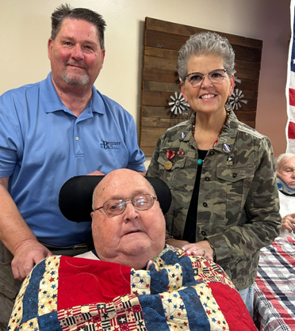U.S. Army veteran Ken Werner was presented with a Quilt of Valor during a ceremony hosted by the Nimble Thimble Quilt Guild on Veterans Day. Pictured with Werner are his children Scott and Mickie. 