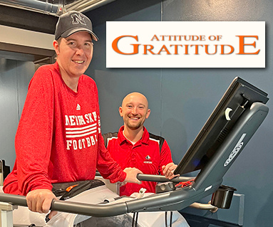 Tyler Nunnenkamp works out on a physical therapy machine at Memorial Rehab in Aurora. With him is his good friend and physical therapist, Kyle Shaffer.