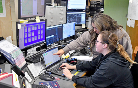 Hamilton County 911 dispatchers Melissa Barry (standing) and Sidney Fochtman have spent numerous hours being trained on how to use the RapidSOS software which allows dispatchers to receive vital medical information when a caller who has elected to share that information calls using a smart phone. 