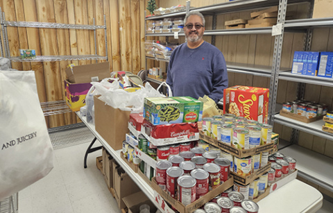 Rudy Flores, pastor of the Messiah Lutheran Church in Aurora, helped deliver a timely donation of 500 pounds of food last week, one of many local food drives anticipated in the next few weeks.