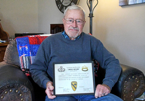E-4 Specialist Ron Elge served in the U.S. Army from 1964-1966 during the Vietnam War. He worked in radio repair for his battalion while stationed at his base camp in An Khe. Elge displays his certificate that received after his service for being a parachute infantryman in the 1st Battalion (Airborne) 8th Cavalry. 