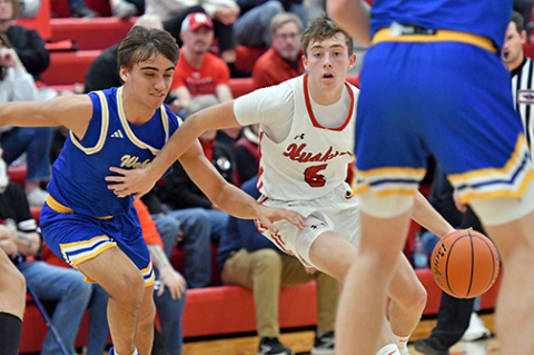 Aurora’s Ryan Staehr dribbles through heavy Wahoo traffic during the Huskies’ 66-43 loss to the Warriors Saturday. 