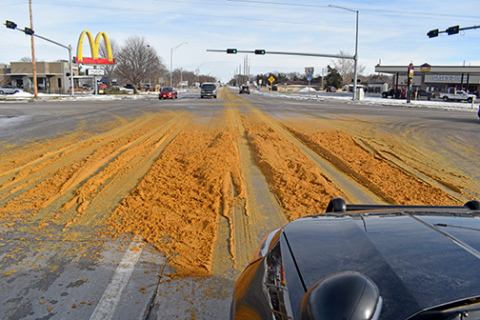 Corn mash covers the intersection of highways 14 and 34 on Tuesday. 