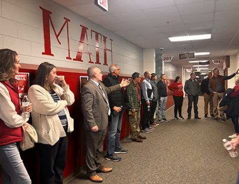 Aurora Supt. Jody Phillips, center, leads a tour of the middle school as part of last week’s three-hour meeting with the community advisory committee.