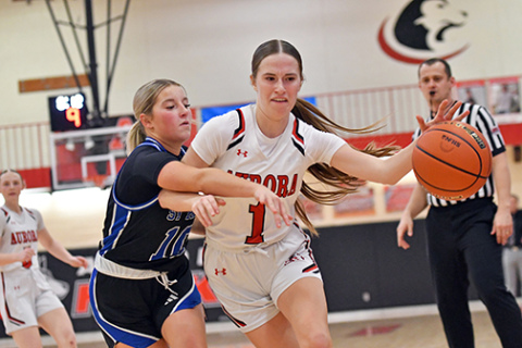 Aurora’s Hailey Hoff dribbles around and through contact during the Huskies’ 55-23 home win over St. Paul Thursday. 