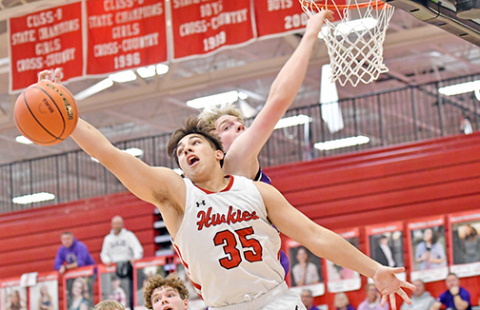 Aurora’s Tucker Theriot battles for an offensive board in the Huskies’ win over Milford Thursday. 