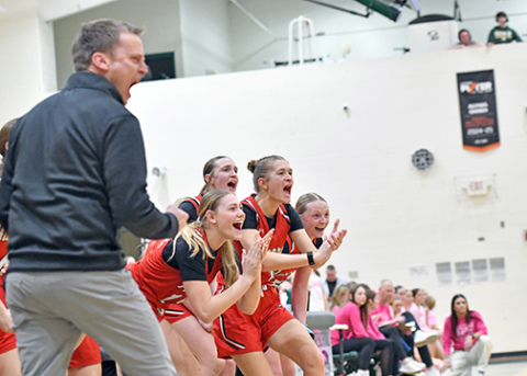 Aurora’s bench celebrates a made bucket during the Lady Huskies’ 52-35 win at Kearney Catholic Thursday. Aurora enters this week’s Central Conference tournament as the No. 1 seed. 