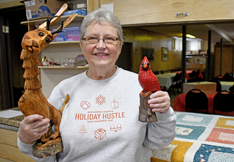 St. John’s Lutheran Church member Opal Christensen shows some of the raffle prizes that will be offered during the church’s annual Aebleskiver feed on Sunday, Feb. 8.