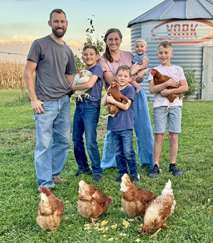 The Bolis family poses for a picture with the laying hens they acquired so their children could go into the egg business. From left are Kevin, Jay, Sally, Emmett, Adalie and João.  