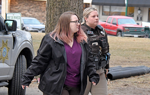 Tiffany Cure is escorted to trial Thursday morning by a deputy sheriff.