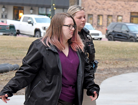 Tiffany Cure is escorted to trial Thursday morning by Deputy Sheriff Victoria Peters. Jurors heard a fourth day of testimony from witnesses for the prosecution on Monday. 