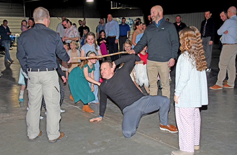 Girl dad Paul Cramer shows how low he can go during the limbo dance. 