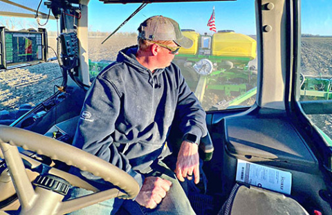 Quentin Connealy looks back at his crops from the seat of his tractor. Connealy, who has been farming full time for the past 15 years, said he has had to deal with increasingly extreme weather. (Photo courtesy of Quentin Connealy)