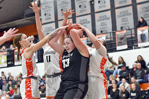 H&H sophomore Sophie Minary is completely surrounded by three Giltner/Harvard defenders, including Tabi Forney (far left), Peyton Schutt (11) and Kailyn Wilson (behind). G/H girls rallied for a 69-63 double overtime win over the Bearcats Friday. 