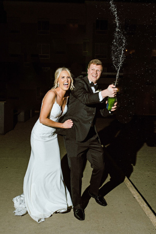 This photo was taken by Laura Oswald during a wedding in downtown Omaha with Laura Oswald using a newer flash setup to add a different dynamic in capturing the couple as the champange sprays. 