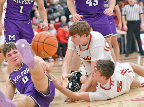 A scramble for the loose basketball between Aurora's Sam Jones (middle) Ryan Staehr (right) and Milford's Connor Adams. 
