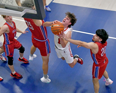Canon Allen goes up strong in the paint surrounded by Crete defenders, part of his 19-point performance in Aurora's 52-41 win over the Cardinals. 