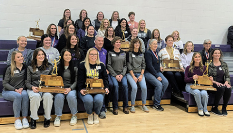 Former Hampton volleyball team members display some of the trophies they won in past years