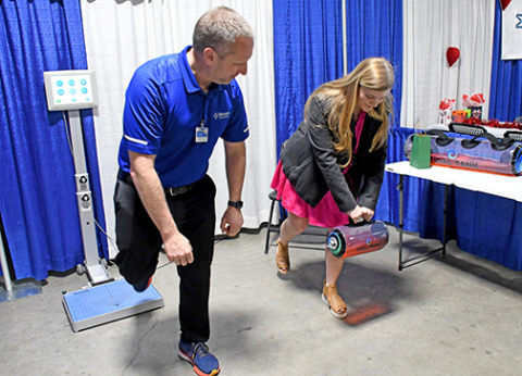 Brad Bangs of MCHI Rehabilitation demonstrates to Lauryn Thomas how a tidal tank can be used to help patients improve coordination and train core and muscles.