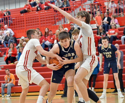 Aurora's Ryan Staehr (left) and Jaxson Slagle defend York's Dylan Oberle. 