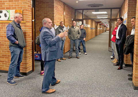 An advisory committee that has been studying the district’s facility needs tours a school facility during a recent meeting.