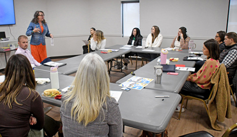 Dena Beck, Central Region Navigator for 6 Regions, One Nebraska, speaks to community members attending the Child Care Conversation hosted March 2 by the Aurora Chamber of Commerce. The lunchtime forum at the Bremer Center attracted more than 20 people to discuss ways to bolster child care options in the area for working families. 