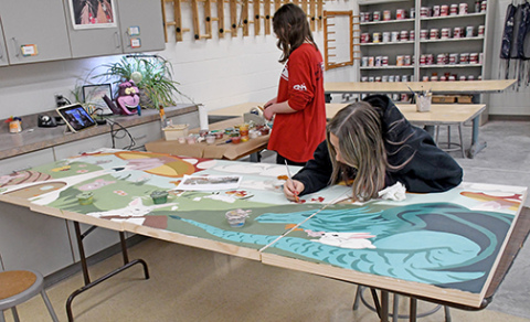 Aurora High School art students work on a new mural for the children's section of the Farr Library