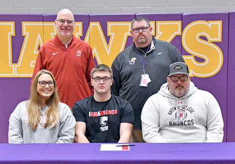 Hampton’s Kyler Luebbe signed with Hastings College to play football March 3, alongside his parents, Heather Reisbeck and Seth Luebbe, as well as Hastings coach Matt Franzen and Hampton coach Jereme Jones. 