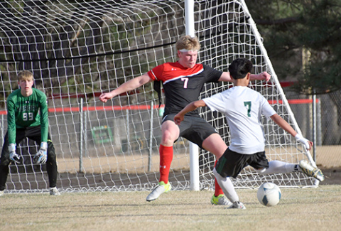 Garrett Kuehner looks to stop the ball on the Schuyler attack during Thursday’s 5-0 loss to the defending champion Warriors. 