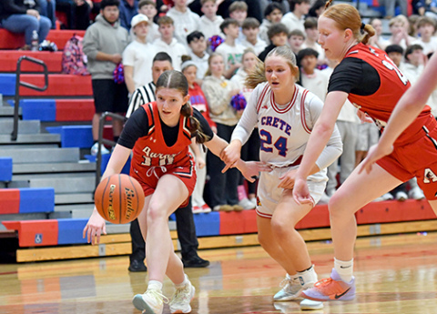 Aurora’s Kenna Merrihew (10) and Evelyn Kraus chase a loose basketball defensively during the Huskies’ season-ending loss to Crete Feb. 25. 
