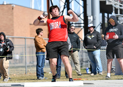 Aurora junior Derek Russell, shown here throwing the shot put at Friday’s Aurora Invite, set a new school record in the discus with a throw of 187-9. Russell won both throwing events on the day. 