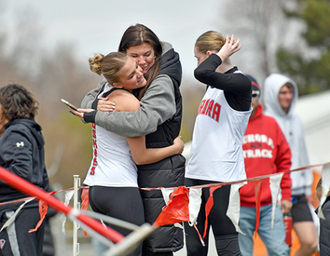 Aurora freshman Stella Peterson gets a big hug from her Mom, Sunny Wendt, after setting a new personal record in the triple jump with a mark of 37-7 to win the event at Broken Bow Friday. 