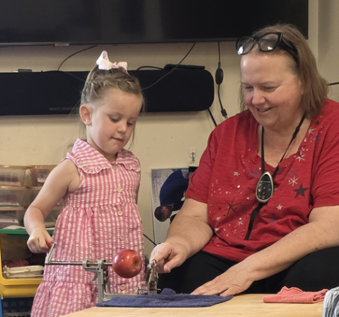 Kathryn Dyer will end a 33-year career in education, spent almost entirely in Aurora, when she retires at the end of the school year. She is shown here working with a student in the preschool building where she spent most of her career.