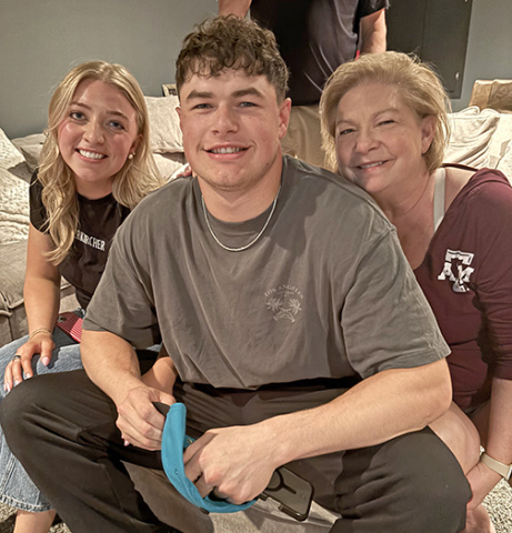 Aurora native Nate Boerkircher holds a Jacksonville Jaguar hat in his hands, shortly after hearing his name called in the second round of the NFL draft. Pictured with him are his fiance, Paxtyn Dummer, and mother Sherry. 