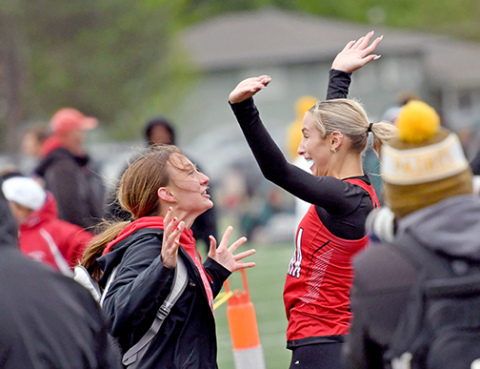 Aurora’s Jordyn Slagle (right) celebrates a new school record of 57.75 in the 400 meter dash with former Husky competitor turned assistant coach Kyla Carlson during Monday’s CNTCs. 