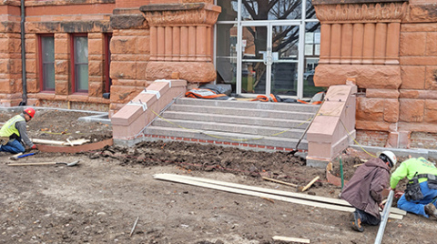 Workers install forms in preparation for pouring new walkways on the west side of the courthouse