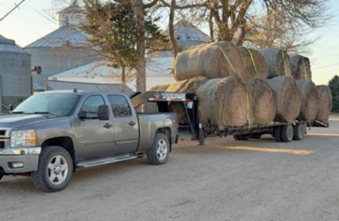 Cale Carson has his trailer loaded with hay bales ready to be taken to Farnham area on March 25 to help feed cattle left hungry by the Cottonwood Fire which burned up thousands of acres of prairie grass earlier in the month. 