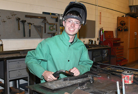 Brett Mellies paused for this photo in the ag shop during his final day of classes at AHS. Mellies plans to study mechanical engineering next fall at UNL.