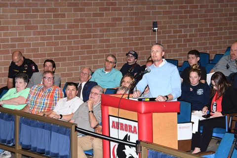 City Administrator Adam Darbro asks a question during Tuesday's city council meeting, which was held at the Aurora Middle School theater.
