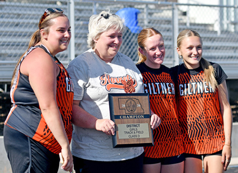 For the first time since its dominant title run a few years back, Giltner’s girls track team won the D-6 district championship in Kenesaw May 13. Posing with coach Nancy Lockmon and the championship trophy are seniors Kailyn Wilson (far left), Avery Reeson and Gracie Kreutz. 