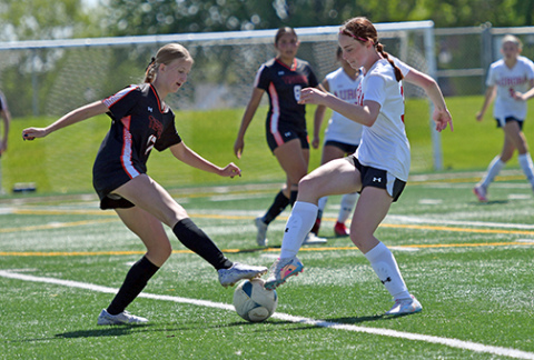 Aurora’s Paityn Wyatt battles for possession near the midfield during the second half of the Lady Huskies’ 1-0 loss to Hastings in Saturday’s B-3 district opener
