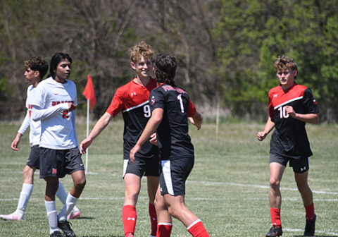 Alex Dick (9) gets congratulated by teammate Canon Allen after one of Dick’s five goals during Saturday’s win over Madison. Dick’s five goals in a single game ties Allen’s single-game school record, which was set earlier this season.