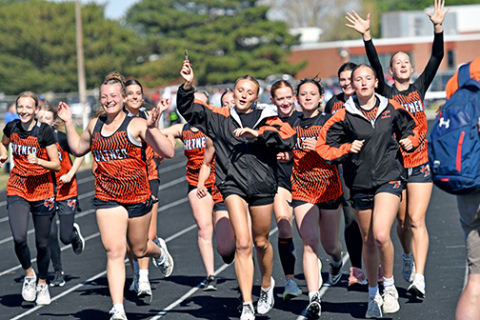 Members of the Giltner girls track team take a celebratory lap around the track after clinching the Twin Valley Conference title Saturday in Shelton. It was the Giltner girls’ first conference title since winning the CRC championship in 2019, part of a five-year run.